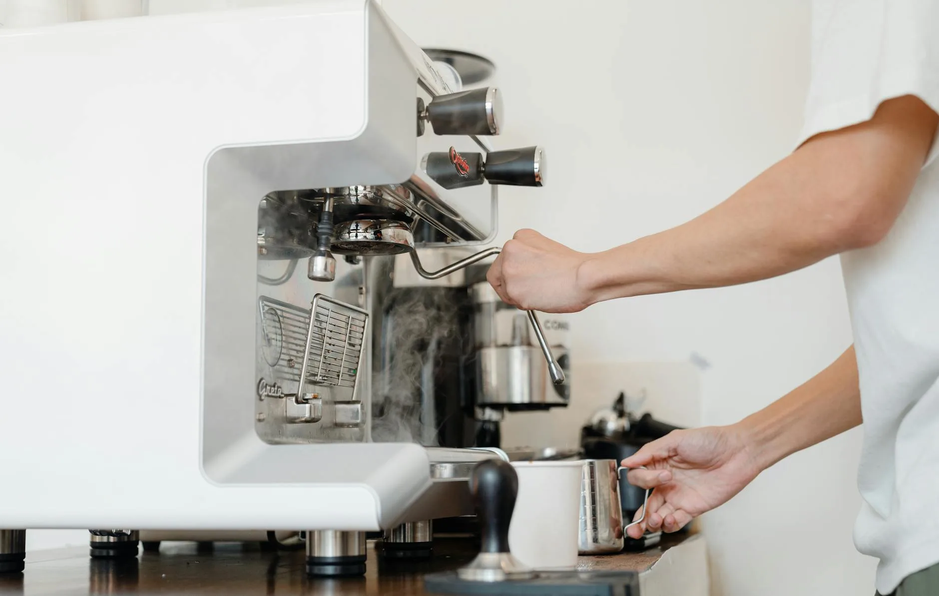 crop barista with jigger and coffee machine cappuccinator