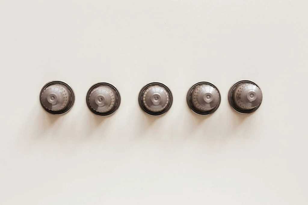set of capsules for espresso machine on white background