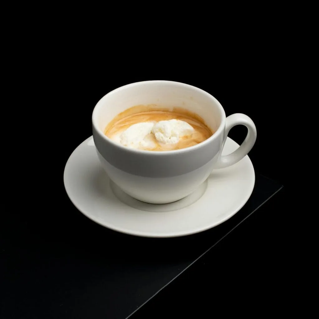an affogato drink on ceramic cup with saucer