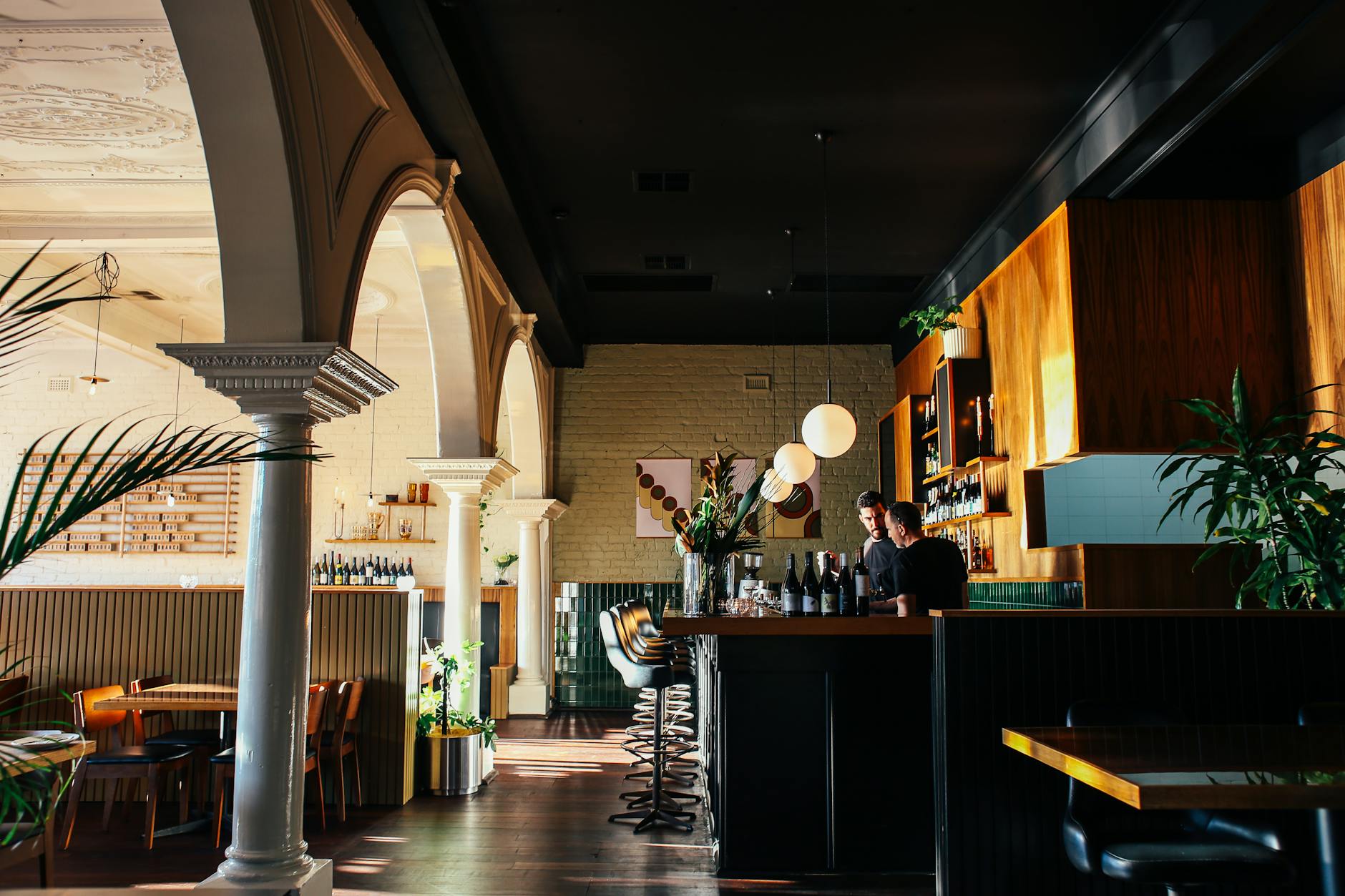 young barmen standing at counter in restaurant