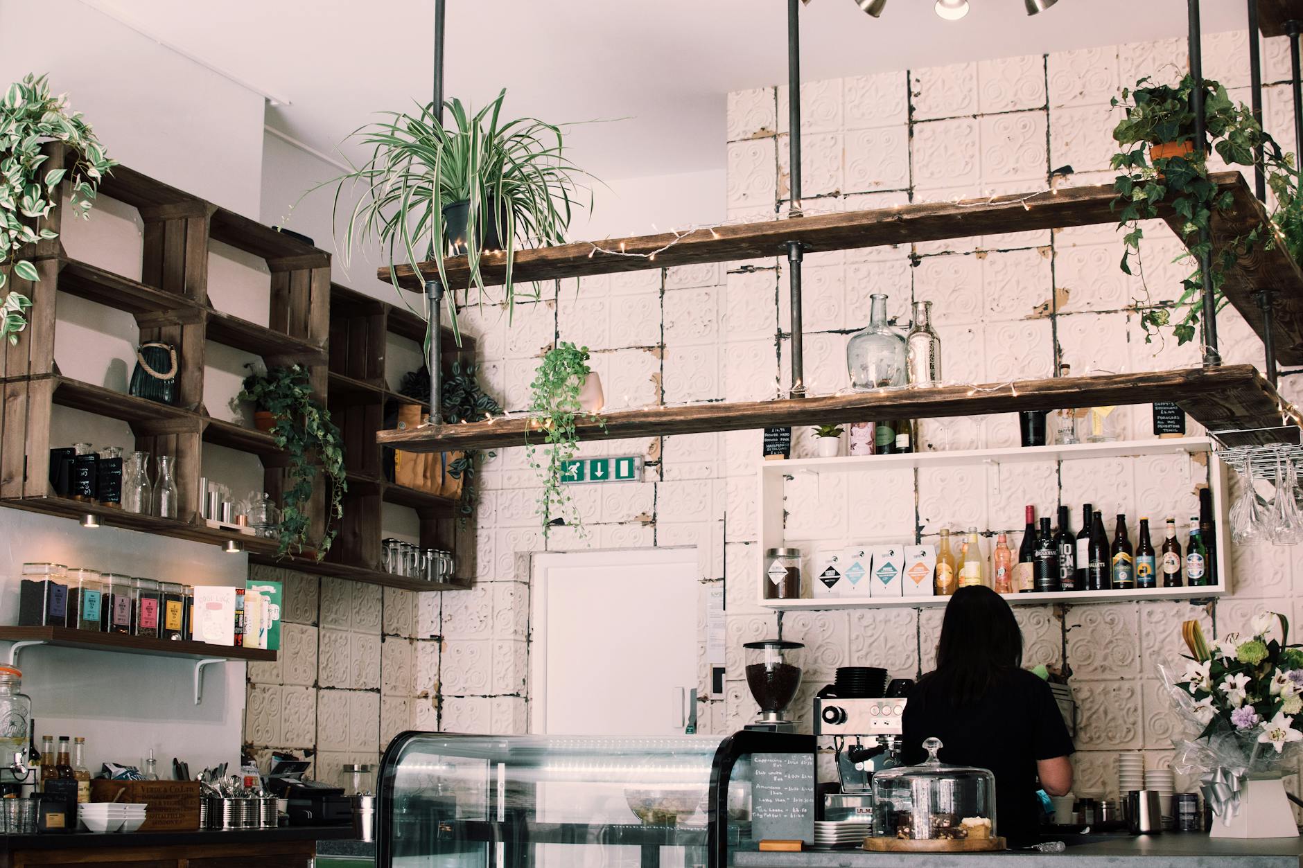 woman beside bottles and cupboard