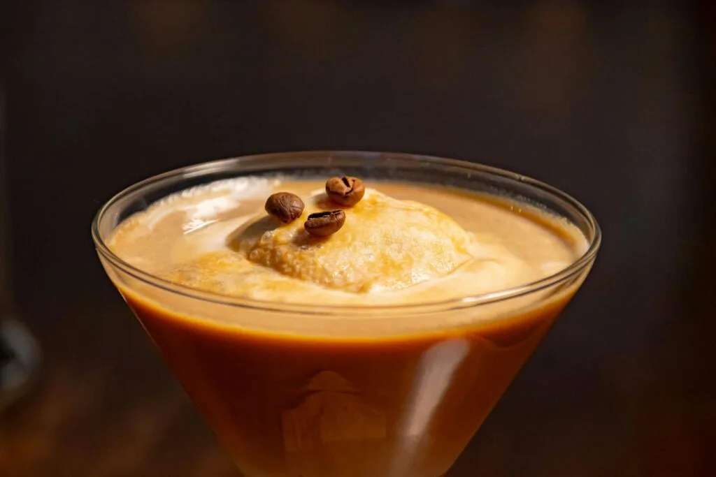 Smooth and creamy coffee drink with a scoop of ice cream, garnished with coffee beans.