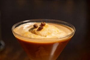 Smooth and creamy coffee drink with a scoop of ice cream, garnished with coffee beans.