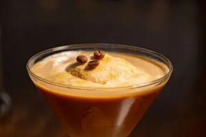 Smooth and creamy coffee drink with a scoop of ice cream, garnished with coffee beans.