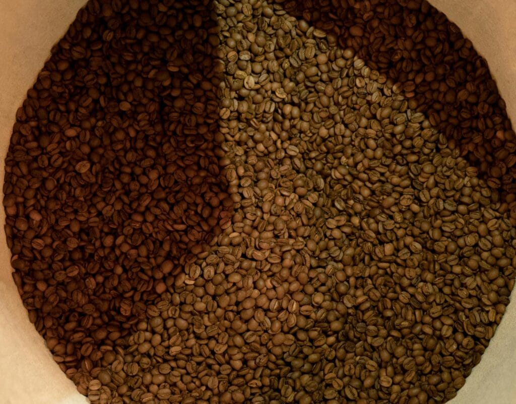 Artistic shot of coffee blends - coffee beans in varying shades, capturing the roasting process.