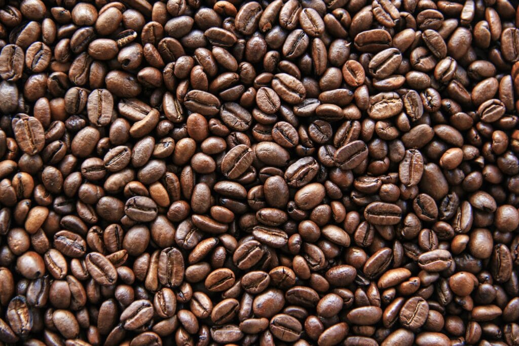 Rich, aromatic coffee beans displayed in a detailed and vibrant close-up view.