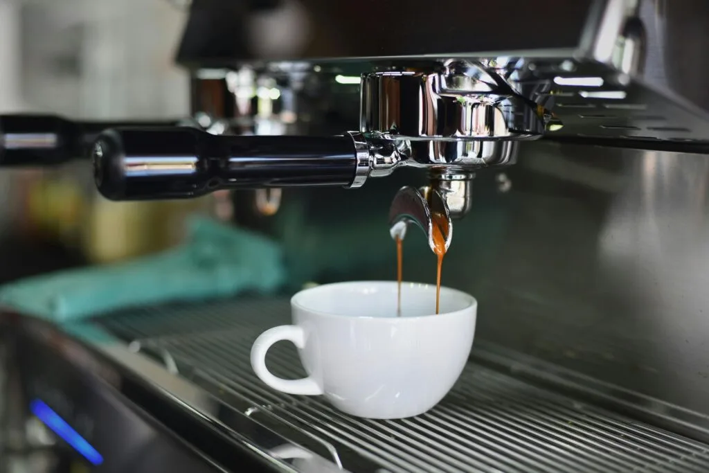 starbucks - coffee beans - Close-up of espresso pouring from a shiny coffee machine into a white cup, perfect for lovers of caffeine and barista art.