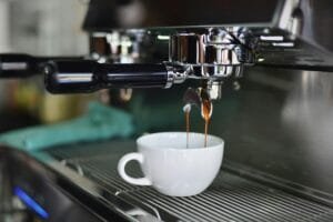 starbucks - coffee beans - Close-up of espresso pouring from a shiny coffee machine into a white cup, perfect for lovers of caffeine and barista art.